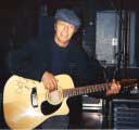 David Bowie with signed guitar